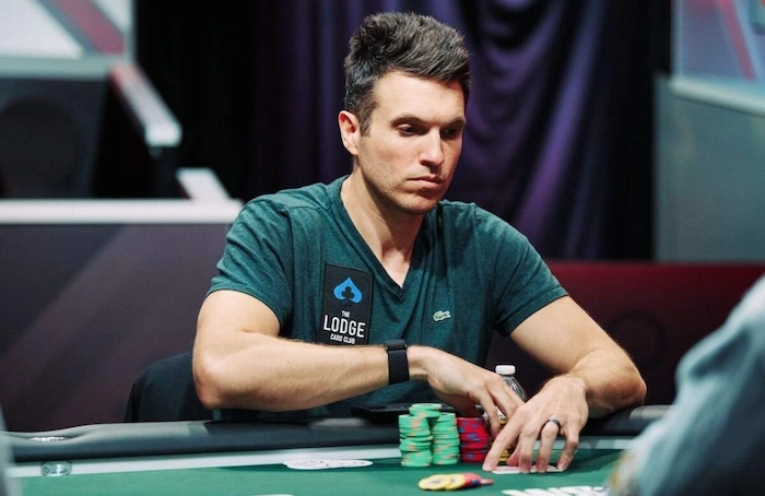 Doug Polk at the Lodge Card Club poker table wearing a Lodge logo tee with chip stacks during a cash game session