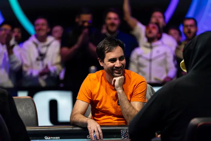 Michael Gagliano smiling at the WSOP 2026 Main Event final table with his rail celebrating behind him