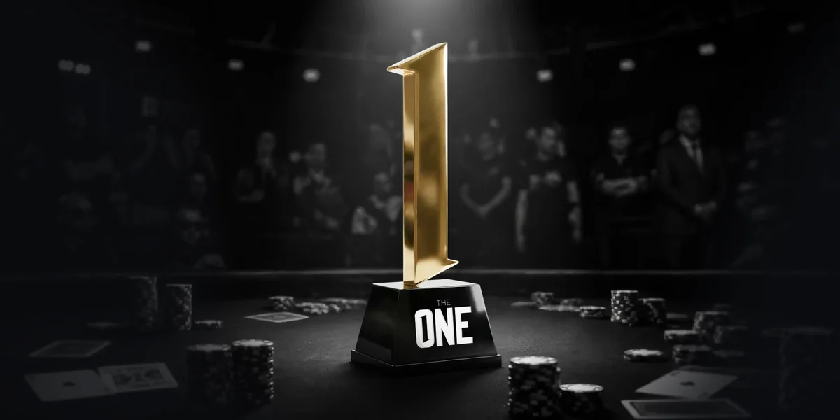 The One trophy on a poker table, a gold number one on a black base with The One lettering, awarded to the winner of CoinPoker's $5,000,000 GTD tournament