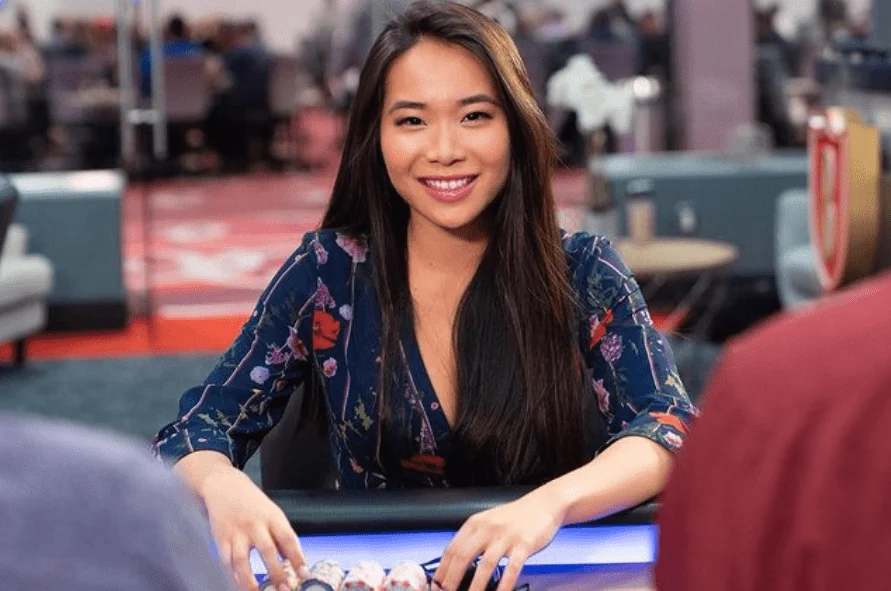 Lynne Ji seated at a poker table with chips in front of her
