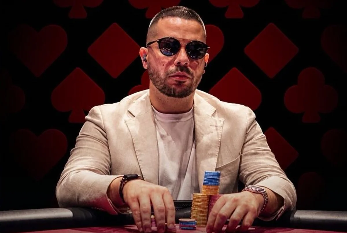 Farid Jattin studio portrait Farid Jattin in sunglasses and a cream blazer at a poker table with chips in front of him